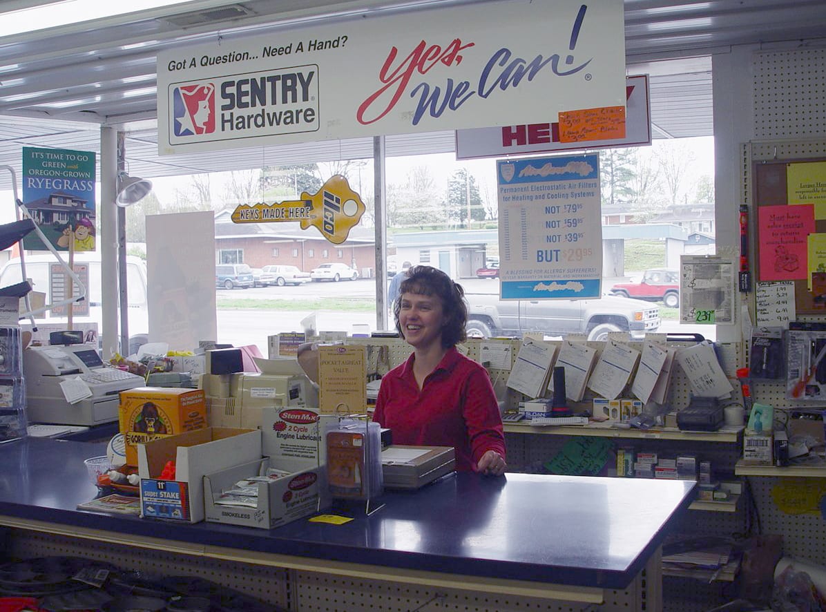 Sentry Hardware cashier attending front counter of the store 